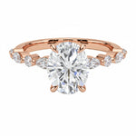 Oval cut Moissanite lab grown diamond engagement ring with tube set small round moissanites on the shank, on a gold band, against a white background.Moissanite engagement ring cape town south africa grand diamonds ralph jacobs jeulia 