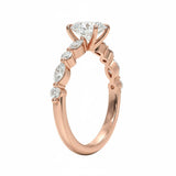 Close-up of a high-quality D-color VVS1 oval moissanite center stone with sharp marquise and round side accents.