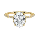 Luxury oval cut moissanite engagement ring in 9ct yellow gold with a double hidden halo and pavé band.