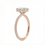 Side profile of a rose gold engagement ring featuring double hidden halos and diamond-encrusted cat claws.