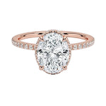 Luxury oval cut moissanite engagement ring in 9ct rose gold with a double hidden halo and pavé band.