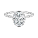 Luxury oval cut moissanite engagement ring in 9ct white gold with a double hidden halo and pavé band.