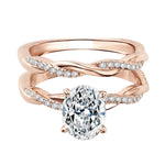 Close-up of a D-color VVS1 oval moissanite in a micro-pavé twisted bridal setting.