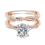 Close-up of a D-color VVS1 oval moissanite in a micro-pavé twisted bridal setting.