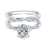 Close-up of a D-color VVS1 oval moissanite in a micro-pavé twisted bridal setting.