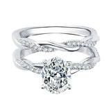 Close-up of a D-color VVS1 oval moissanite in a micro-pavé twisted bridal setting.