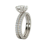 Top-down view of a D-color VVS1 oval moissanite set with matching full circle lab grown diamond-style band.