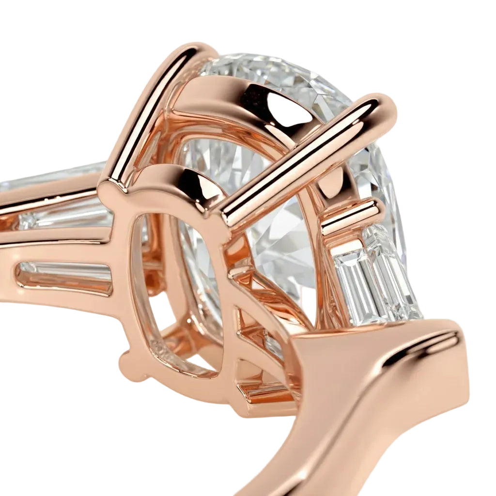 Rose gold ring with a large diamond and smaller baguette-cut diamonds on a white background
