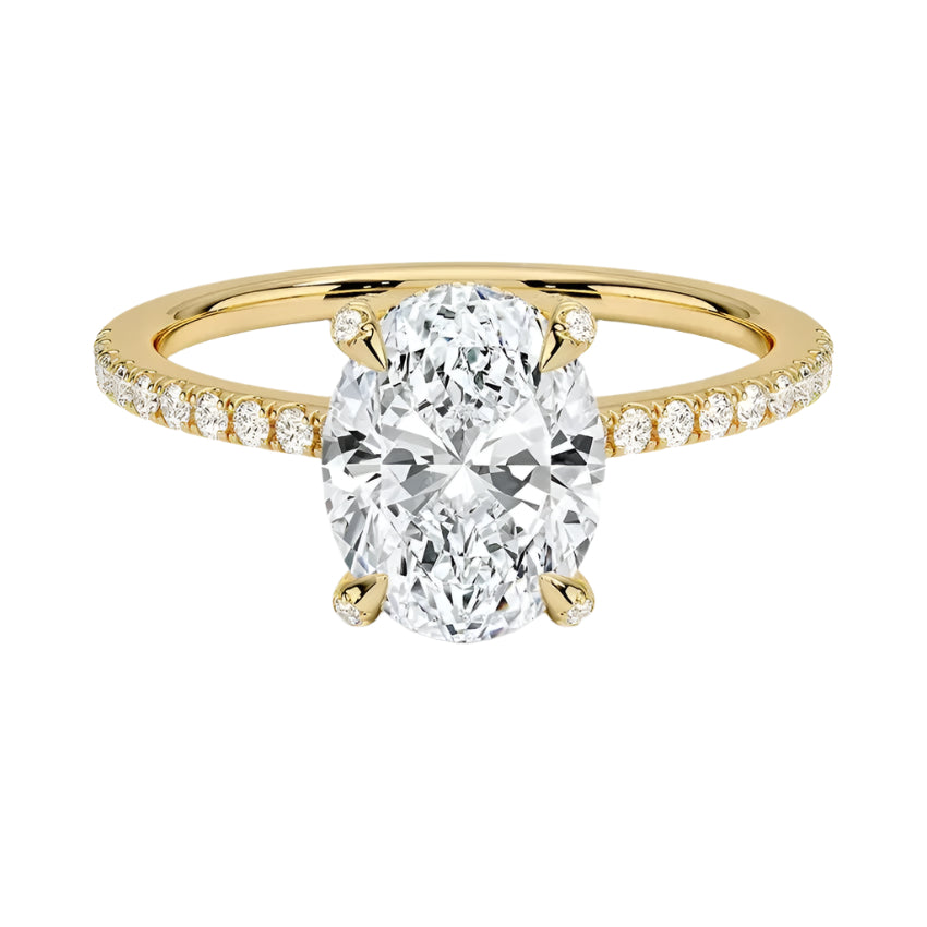 Dainty four-claw oval moissanite ring with hidden halo and encrusted prongs in yellow gold ApolloGem.