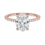 Dainty four-claw oval moissanite ring with hidden halo and encrusted prongs in rose gold ApolloGem.