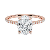 Dainty four-claw oval moissanite ring with hidden halo and encrusted prongs in rose gold ApolloGem.