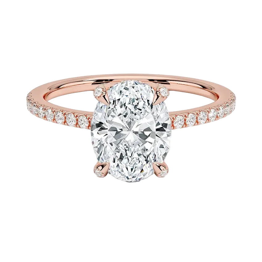 Dainty four-claw oval moissanite ring with hidden halo and encrusted prongs in rose gold ApolloGem.