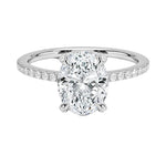 Dainty four-claw oval moissanite ring with hidden halo and encrusted prongs in white gold ApolloGem.