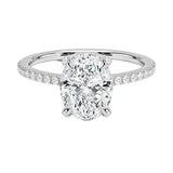 Dainty four-claw oval moissanite ring with hidden halo and encrusted prongs in white gold ApolloGem.