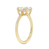 Top-down view of a D-color VVS1 oval brilliant stone in a yellow gold pavé-set setting.