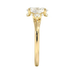 Side profile of a gold engagement ring showing a secret hidden halo micro-pavé setting under the oval moissanite for extra brilliance from every angle.