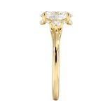 Side profile of a gold engagement ring showing a secret hidden halo micro-pavé setting under the oval moissanite for extra brilliance from every angle.