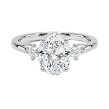 Modern bridal jewelry stack featuring an oval-cut three-stone moissanite ring paired with a slim gold wedding band for a timeless luxury look.