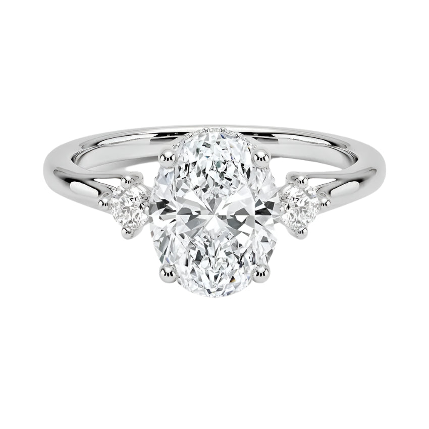 Modern bridal jewelry stack featuring an oval-cut three-stone moissanite ring paired with a slim gold wedding band for a timeless luxury look.