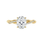 Luxury oval cut moissanite engagement ring with a twisted infinity pavé band in yellow gold ApolloGem South Africa.