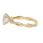 Detailed side view of an oval infinity twist ring showing the intertwined shank and professional four-prong setting.