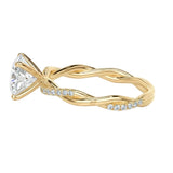 Detailed side view of an oval infinity twist ring showing the intertwined shank and professional four-prong setting.