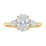Luxury oval cut moissanite engagement ring in yellow gold with two elegant pear cut side stone accents ApolloGem South Africa.