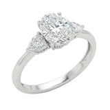 Close-up of a high-quality D-color VVS1 oval moissanite center stone with pear accents guaranteed by a GRI certificate.