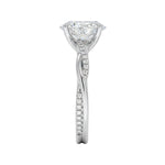 Top-down view of a D-color VVS1 oval stone in an asymmetrical white gold cat-claw setting.