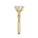 Top-down view of a D-color VVS1 oval stone in an asymmetrical yellow gold cat-claw setting.