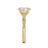 Top-down view of a D-color VVS1 oval stone in an asymmetrical yellow gold cat-claw setting.