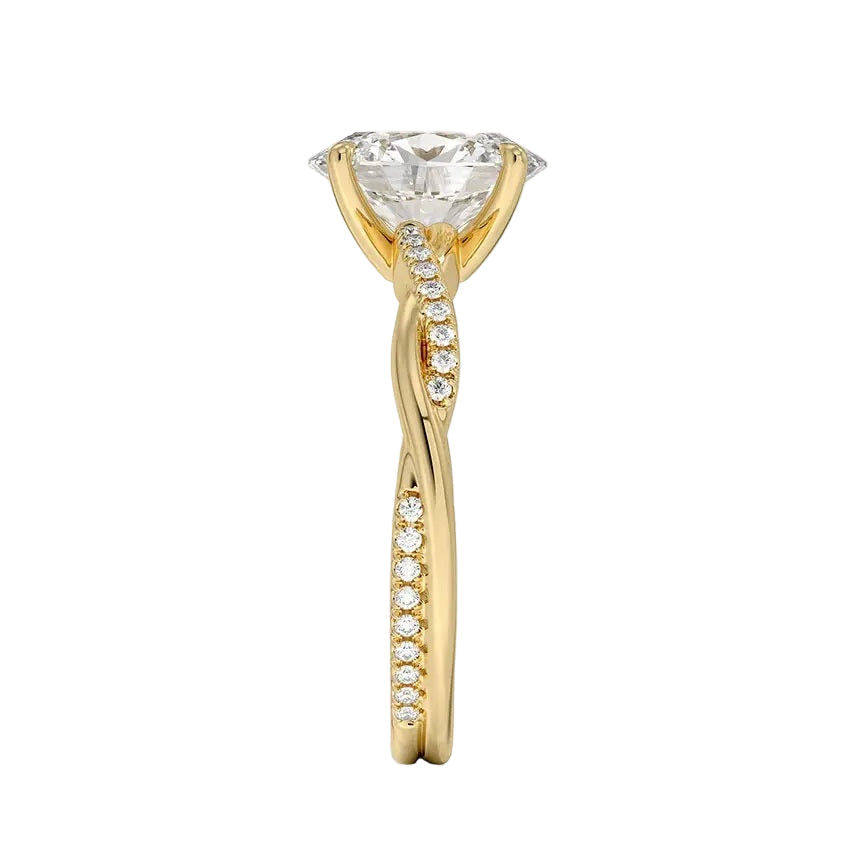 Top-down view of a D-color VVS1 oval stone in an asymmetrical yellow gold cat-claw setting.