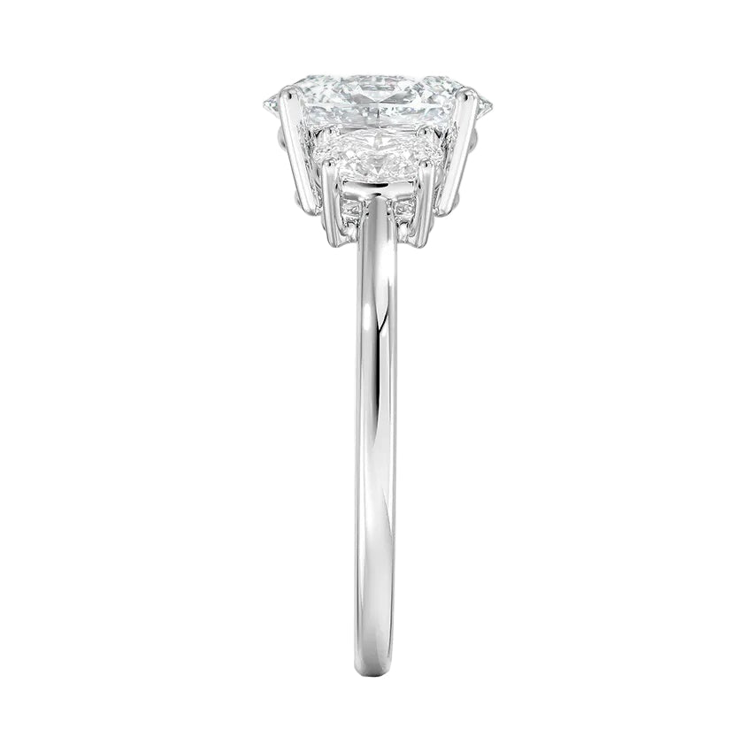 Top-down view of a D-color VVS1 graduated three-stone oval moissanite ring.
