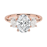 Oval brilliant cut moissanite trilogy engagement ring in rose gold ApolloGem.