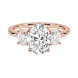Oval brilliant cut moissanite trilogy engagement ring in rose gold ApolloGem.