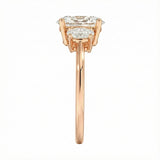 Top-down view of a D-color VVS1 graduated three-stone oval moissanite ring.