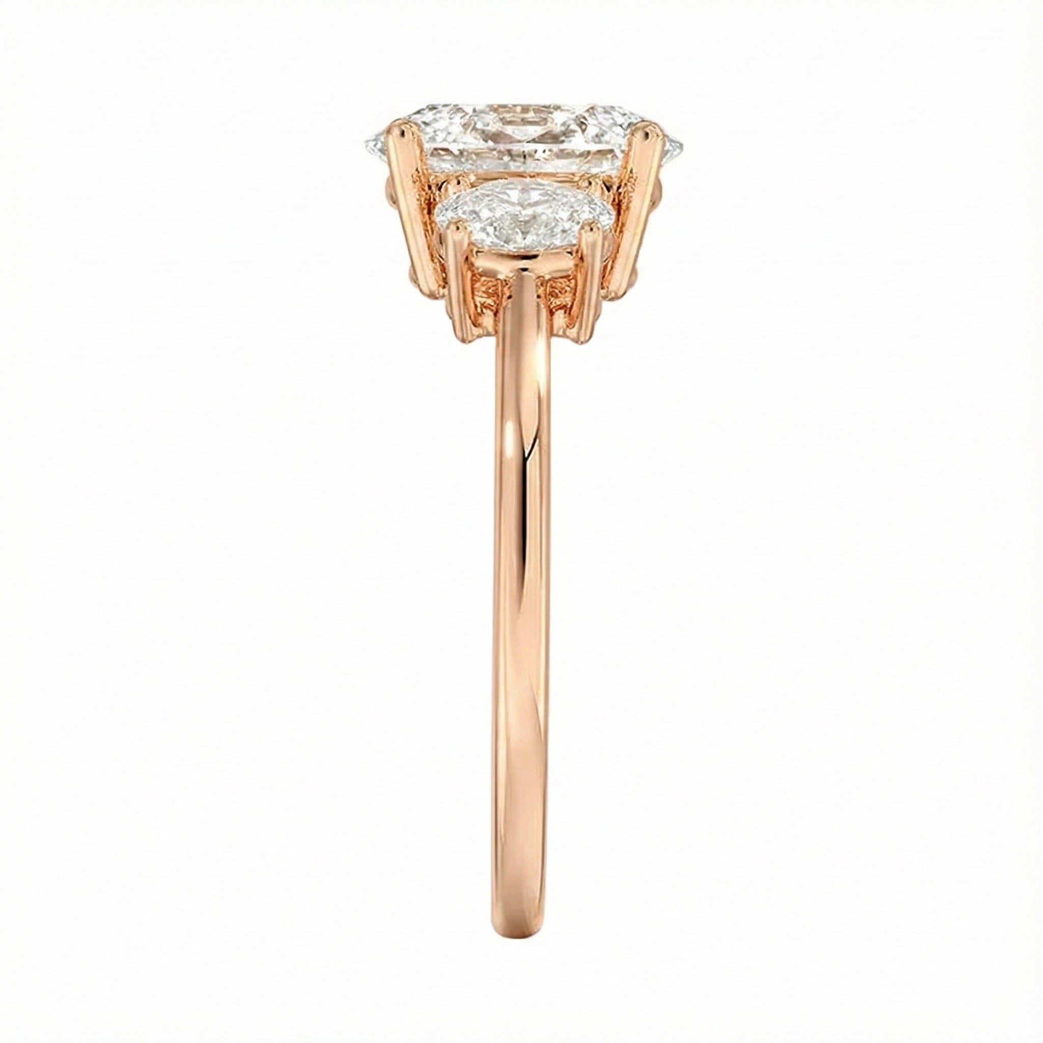 Top-down view of a D-color VVS1 graduated three-stone oval moissanite ring.