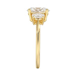 Top-down view of a D-color VVS1 graduated three-stone oval moissanite ring.