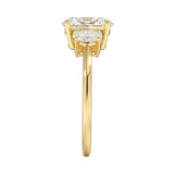 Top-down view of a D-color VVS1 graduated three-stone oval moissanite ring.