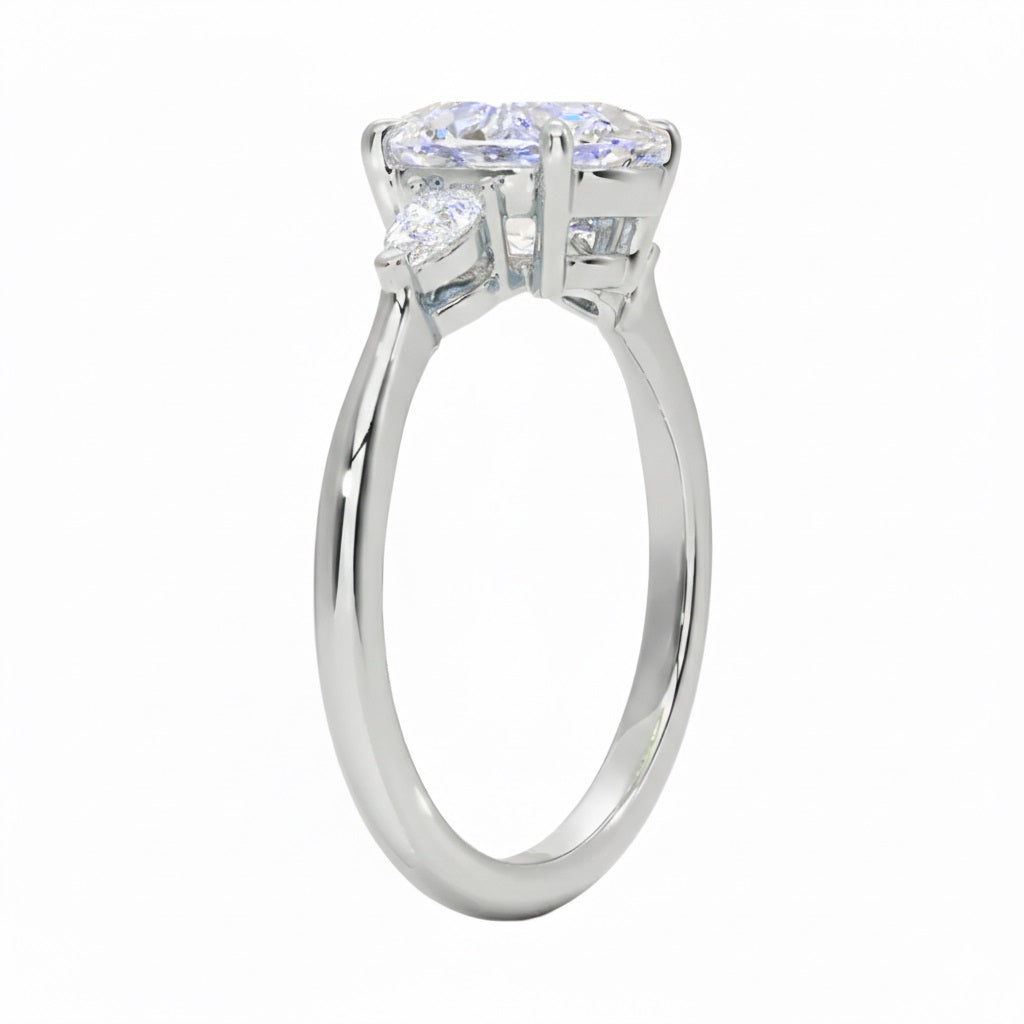 Close up of oval and pear cut moissanite stones in four prong setting