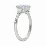 Close up of oval and pear cut moissanite stones in four prong setting