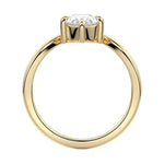 Symmetrical top-down view of a pear-cut moissanite solitaire on a polished V-shaped gold band.