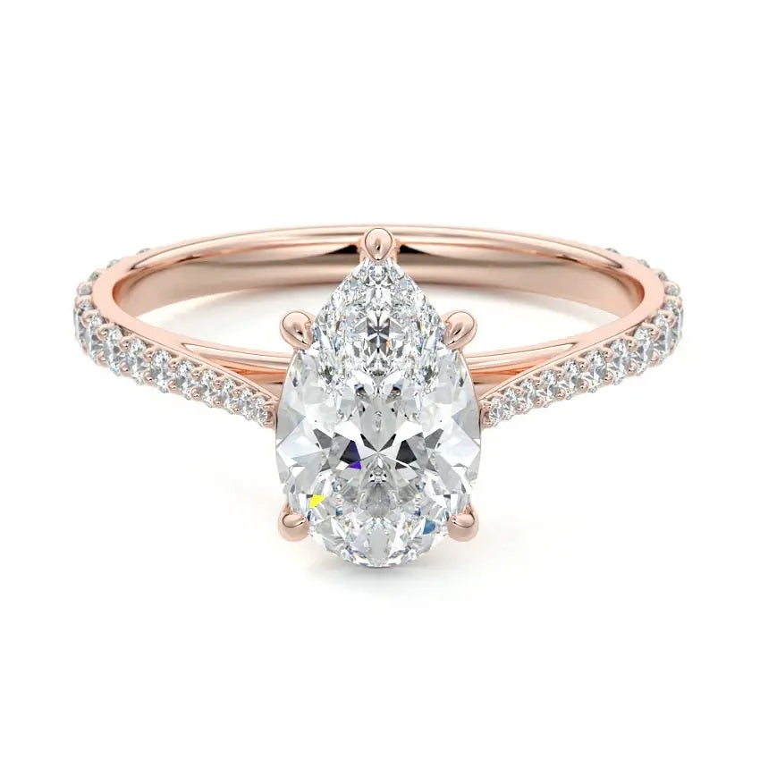 Sculpted five-claw pear cut moissanite cathedral ring with a tapered pavé gold band ApolloGem.