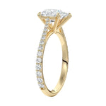 Top-down view of a D-color VVS1 pear stone in a yellow gold tapering pavé cathedral setting.