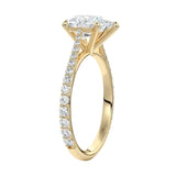 Top-down view of a D-color VVS1 pear stone in a yellow gold tapering pavé cathedral setting.