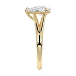 Symmetrical top-down view of a pear-cut moissanite solitaire on a decorative split yellow gold band.