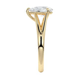Symmetrical top-down view of a pear-cut moissanite solitaire on a decorative split yellow gold band.
