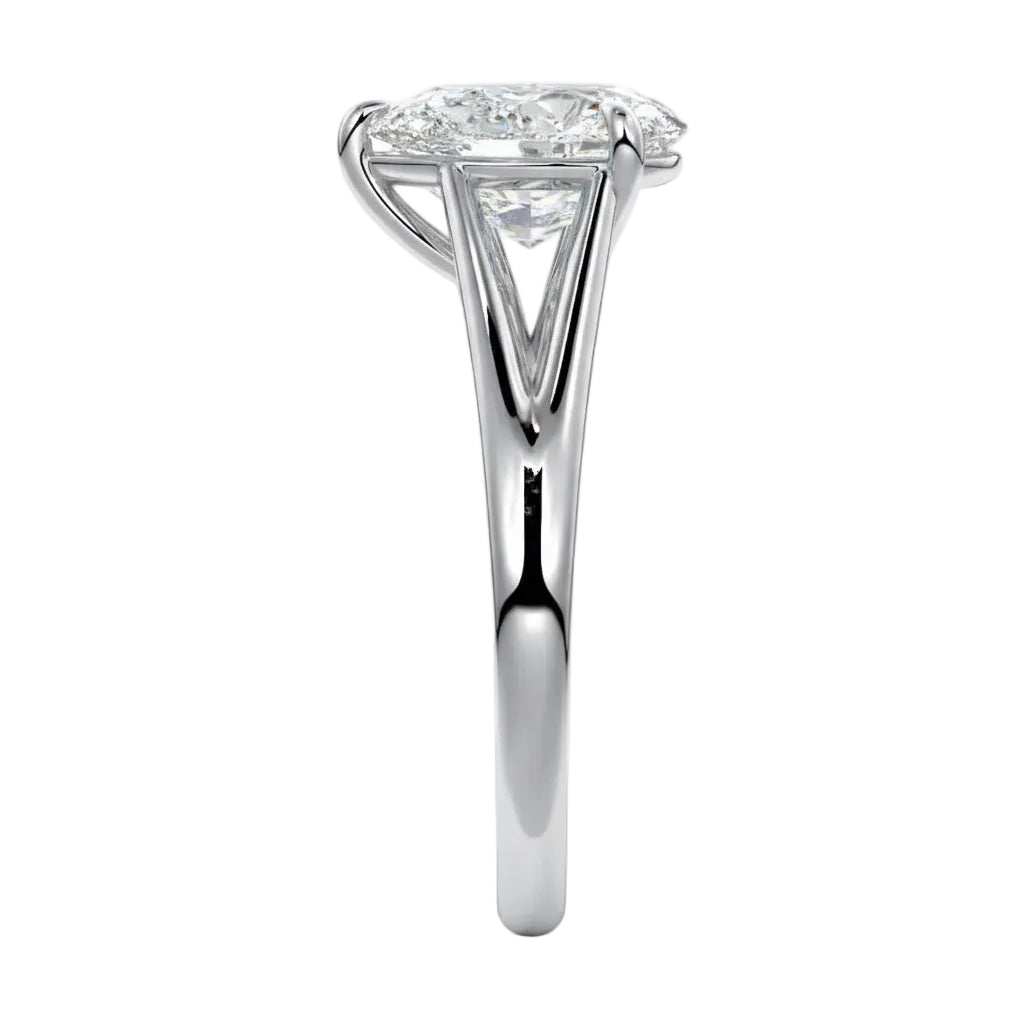 Symmetrical top-down view of a pear-cut moissanite solitaire on a decorative split white gold band.