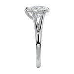 Symmetrical top-down view of a pear-cut moissanite solitaire on a decorative split white gold band.