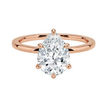 Close-up of a high-quality D-color VVS1 pear cut moissanite in a simple and elegant gold setting.